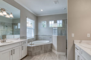 bathroom with large tub and shower