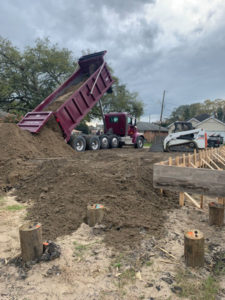 truck dumping dirt onto lot