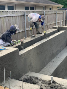 closeup of workers building new foundation