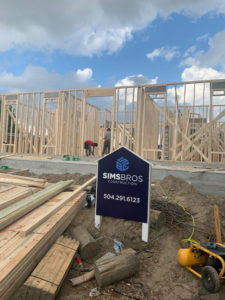 Sims Bros Construction sign in front of new house