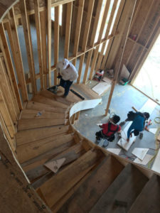 two construction workers building stairs